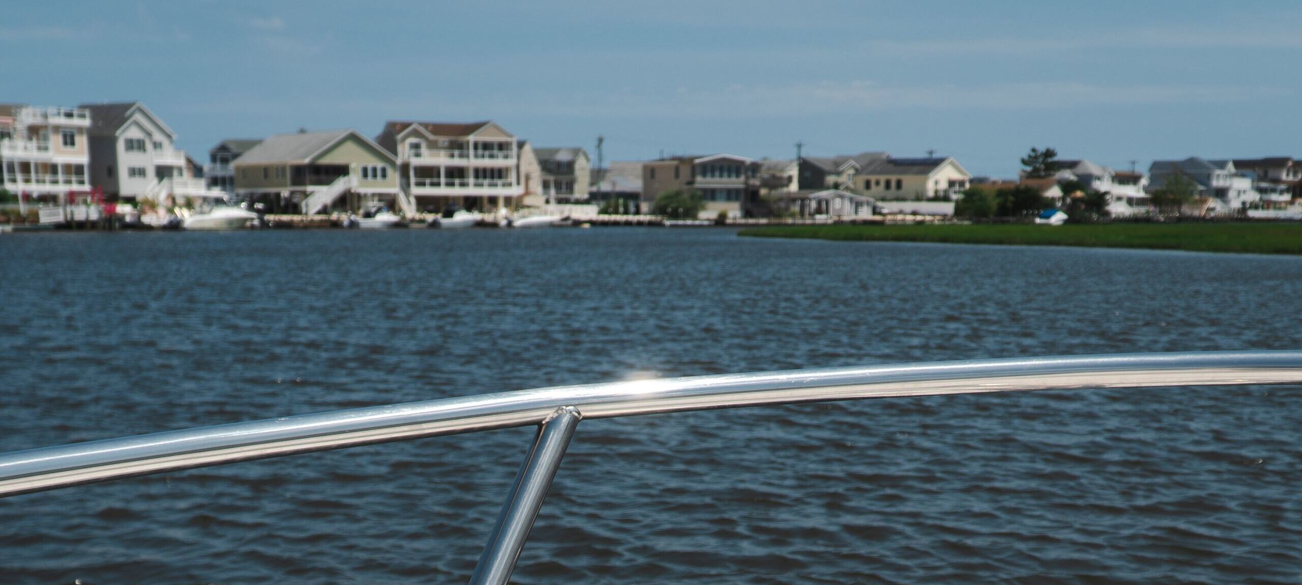 Bayfront homes in the Jersey Shore from a private yacht. Photo by Jayson Boesman on Unsplash