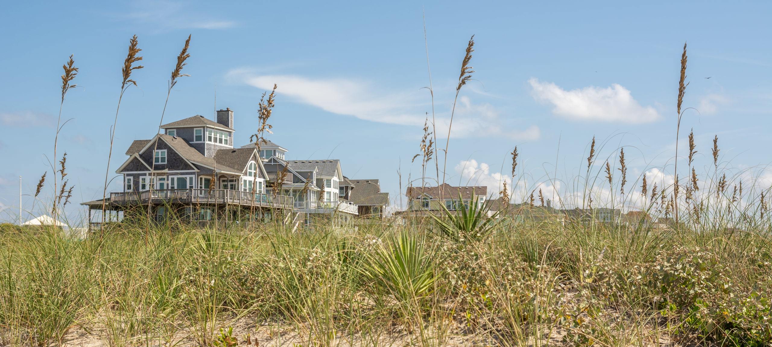 Oceanfront homes along the Jersey Shore with long green grasses on the dunes