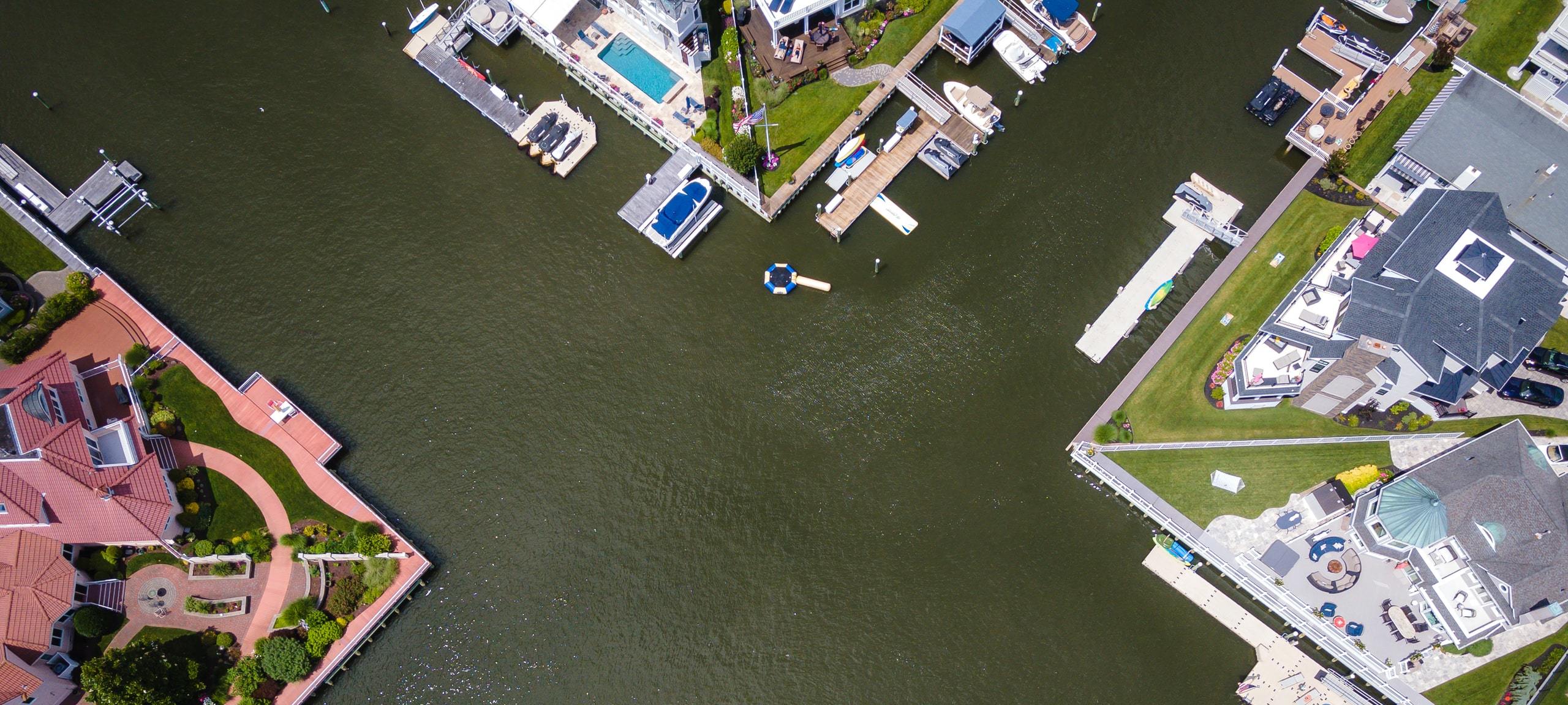 Aerial view of luxury waterfront real estate in Jersey Shore area, with private docks
