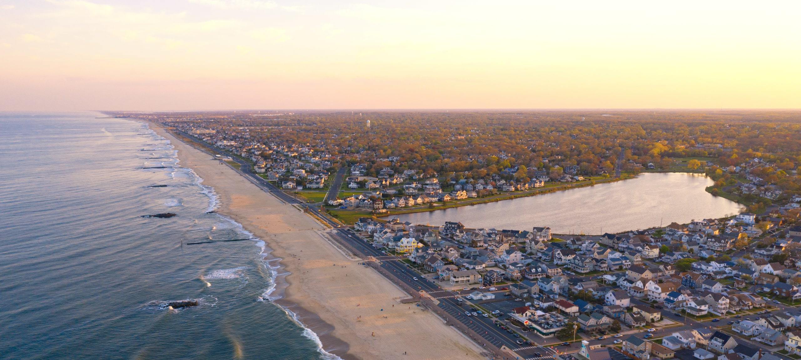 Aerial view over Belmar Beach and Lake Como, NJ during sunset